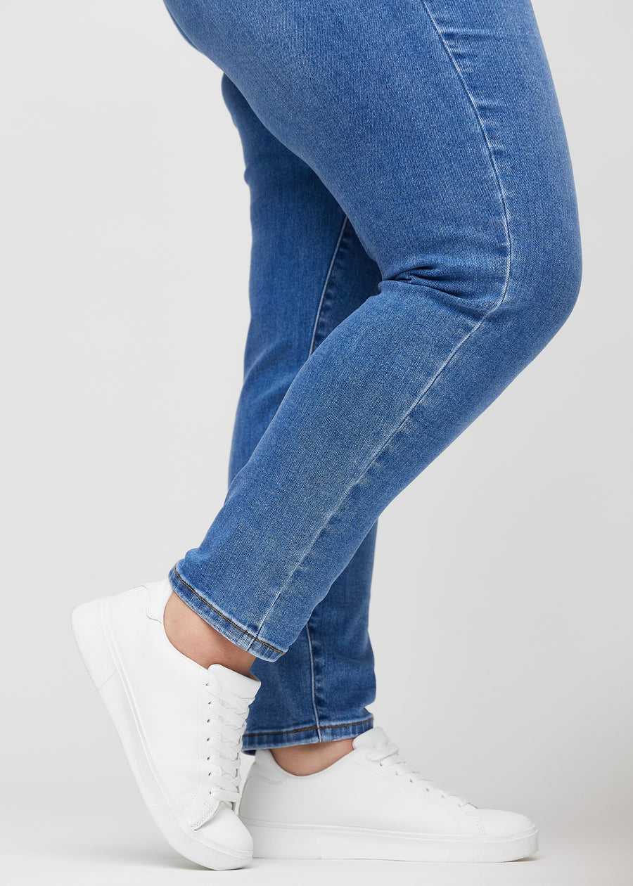 Anklerne på en plus-size model, så man kan se, hvor tæt jeansene sidder.