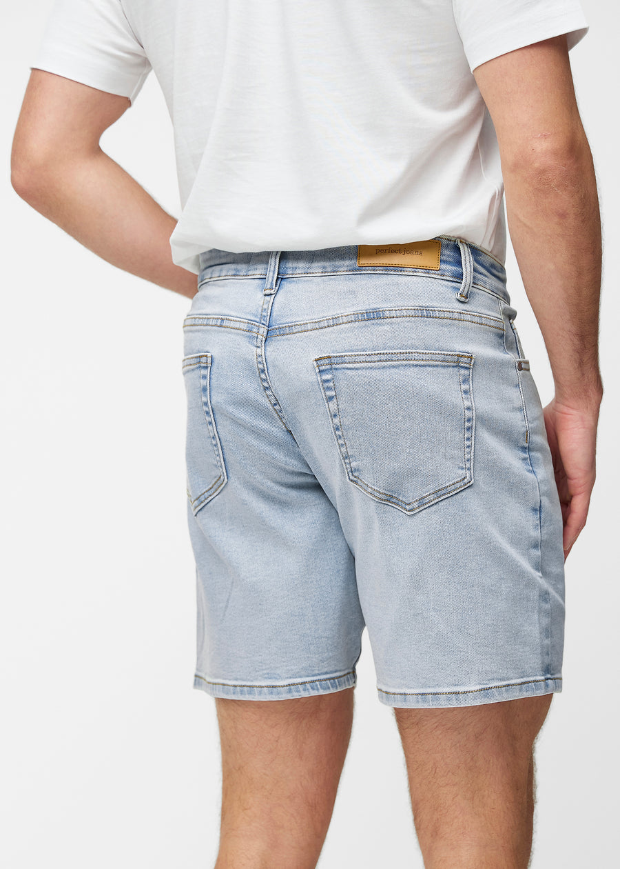 Light blue denim shorts for men in the colour Waves seen from the back up close to show fit and details.