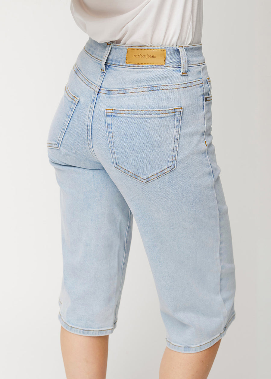 Close-up back view of loose, light blue Waves denim capris, showing the fit and details.