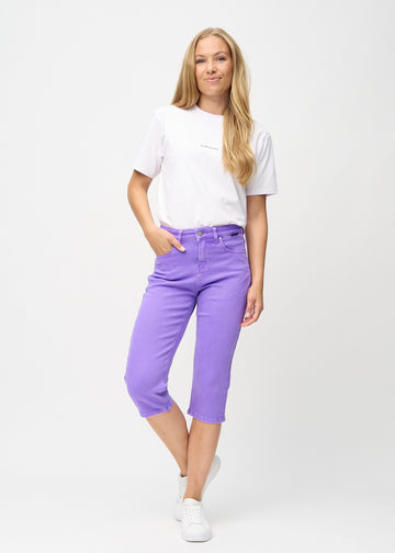 Full-length image of model in purple regular capris.