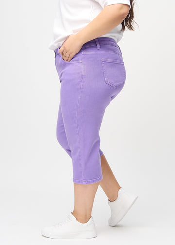 Purple regular capris seen from the side on a plus-size model.