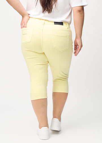 Light yellow skinny capris, back view on a plus-size model, showing the full product.