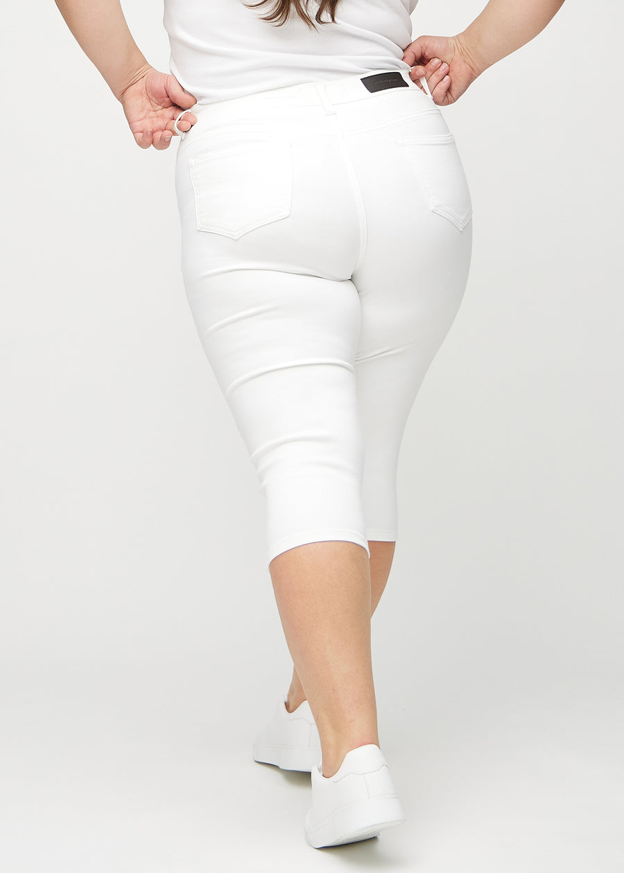 White skinny capris seen from the back on a plus-size model, so the entire product can be seen.