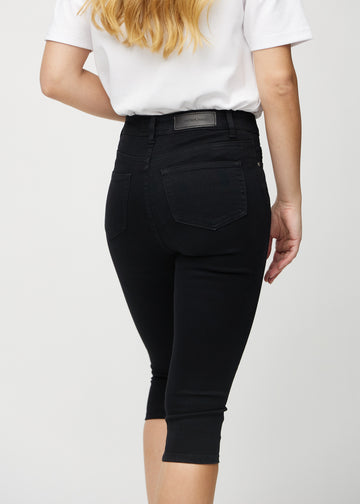 Black skinny capris seen from the back close up to show details.