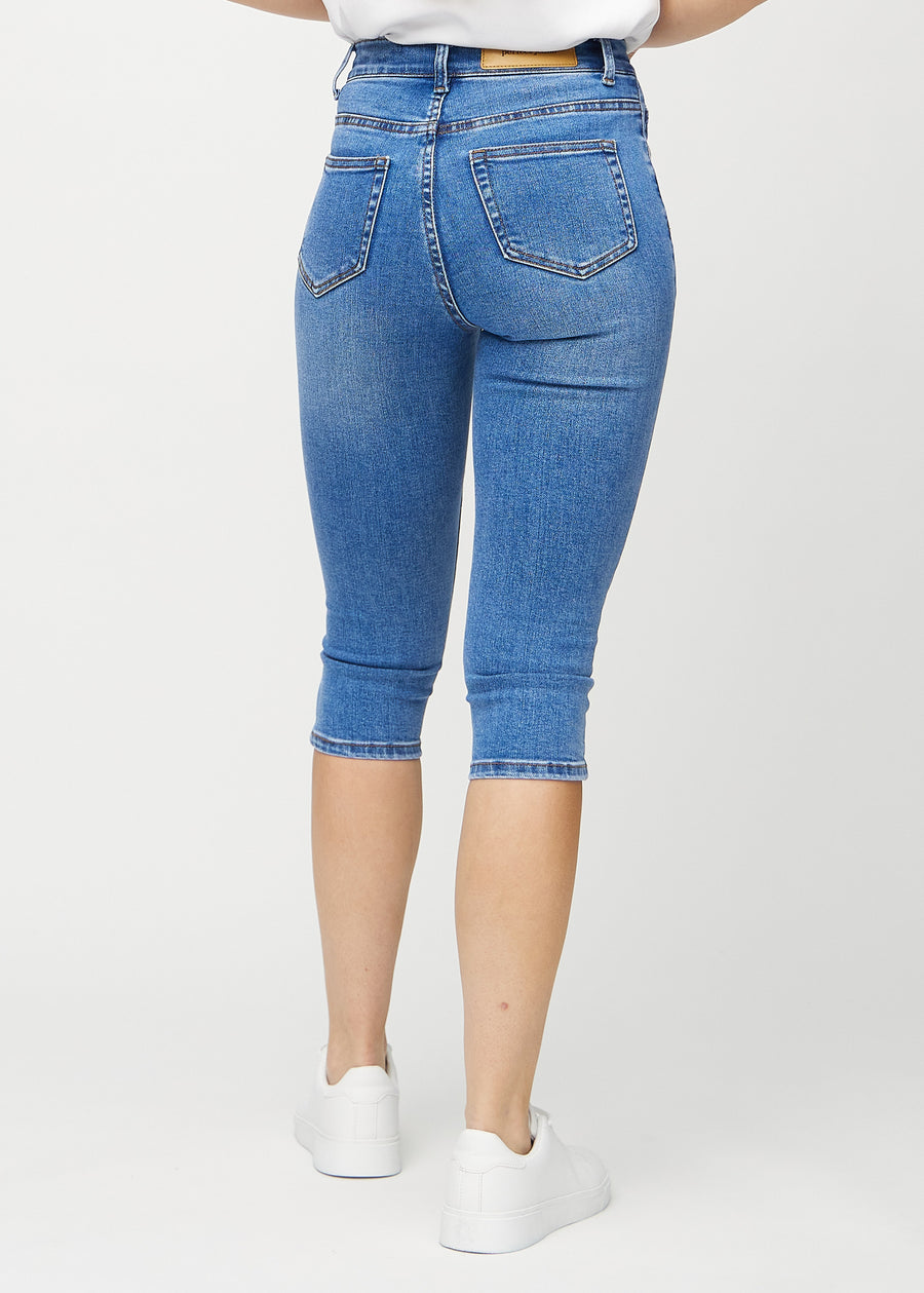 Denim skinny capris seen from the back, so the entire product can be seen.