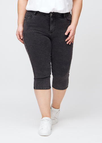 Woman wearing dark grey Shadows denim capris in a skinny fit from Perfect Jeans.
