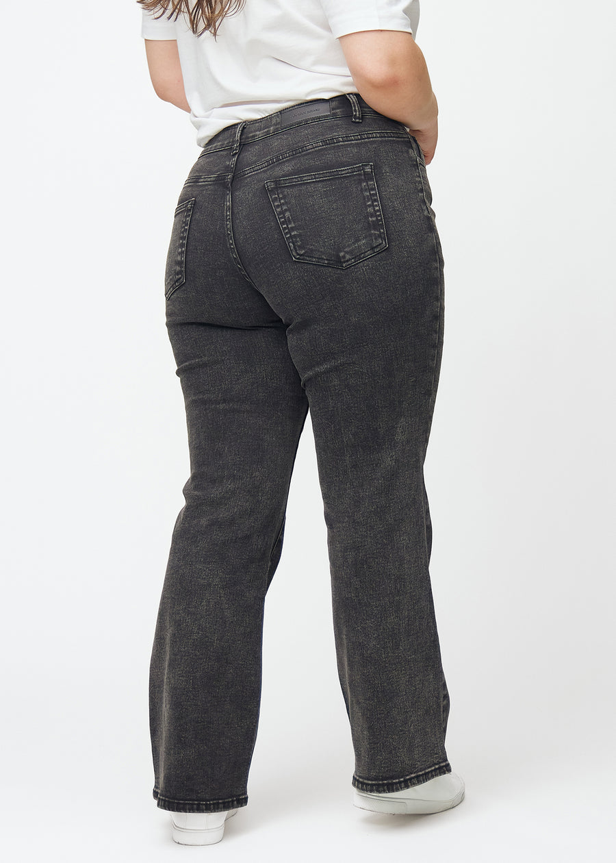 Dark grey mid-rise bootcut jeans in Shadows. Back view on a plus-size model, showing the full fit.