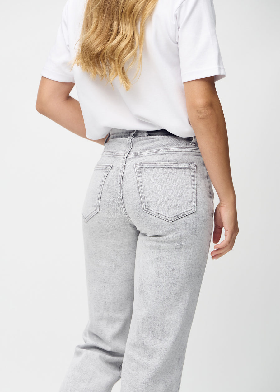 Light grey denim loose jeans seen from the back close up to show details.