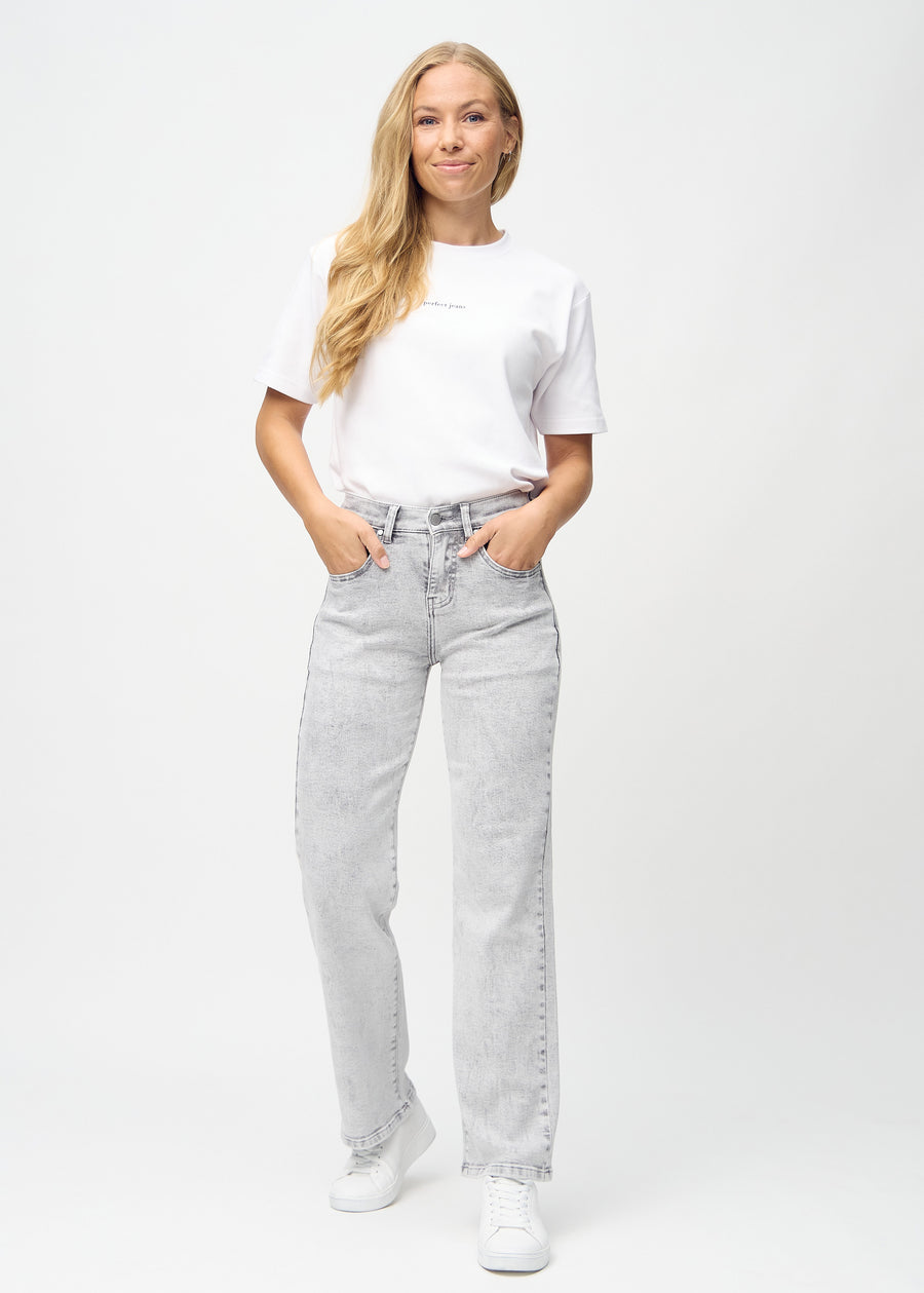 Full image of a model in light grey denim loose jeans.