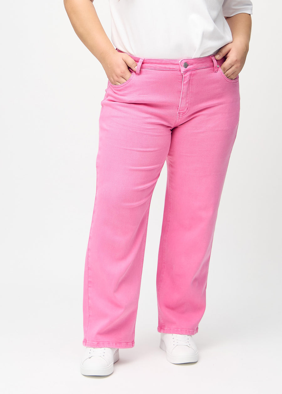 Loose jeans for women in light pink, color Flamingos. Front view on a plus-size model, showing the roomy, wide-leg fit.