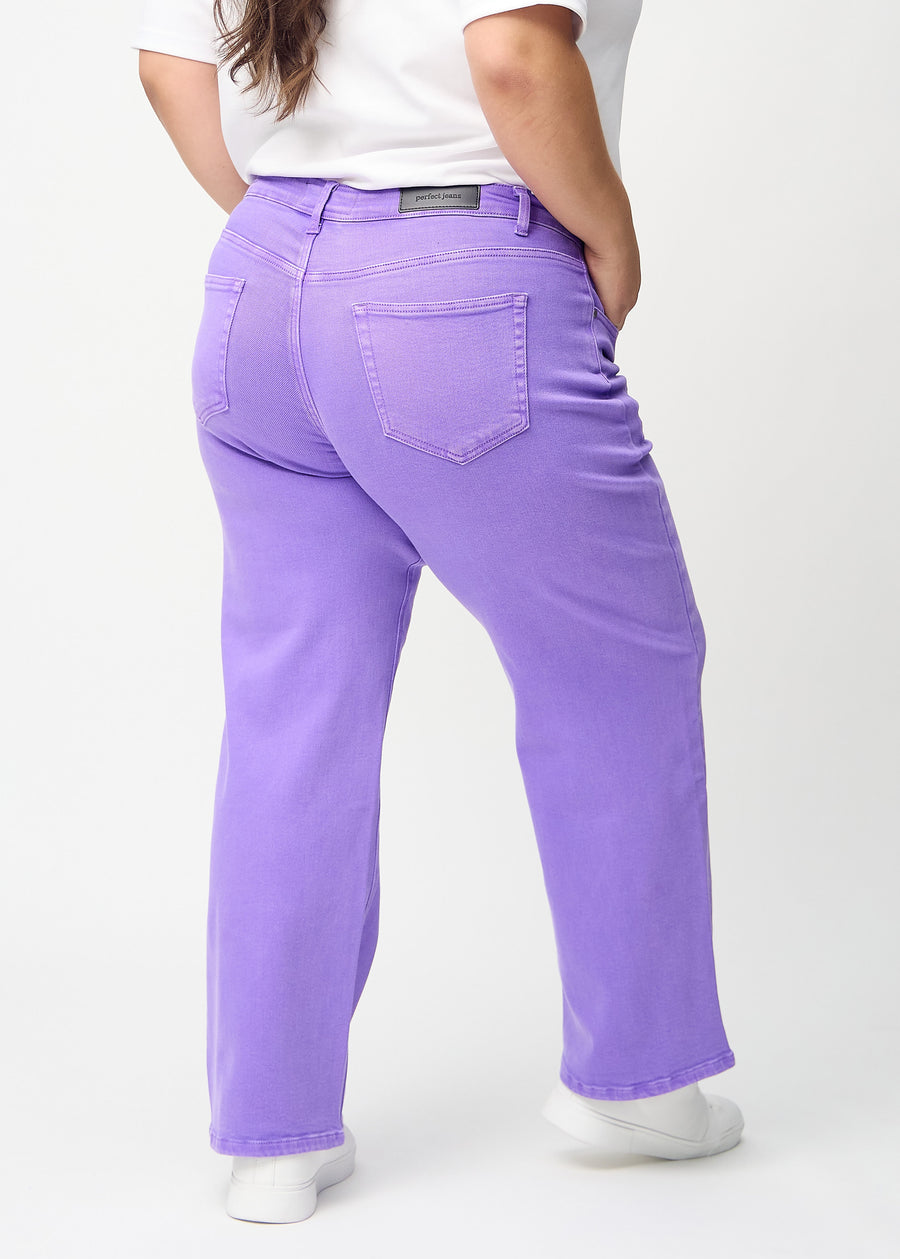 Purple loose jeans seen from the back on a plus-size model, so the full product can be seen.
