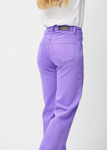 Purple loose jeans seen from the back up close to show details.
