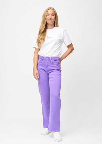 Full image of a model in purple loose jeans.
