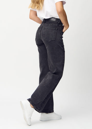 Dark grey denim loose jeans seen from the back, so the entire product can be seen.