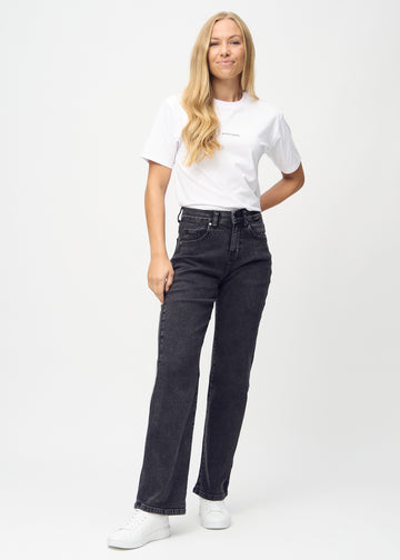 Full image of model in dark grey denim loose jeans.