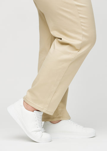 The ankles of a plus-size model, so you can see how loose the jeans fit.