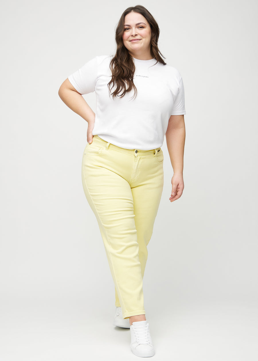Full image of a plus-size model in light yellow regular jeans.