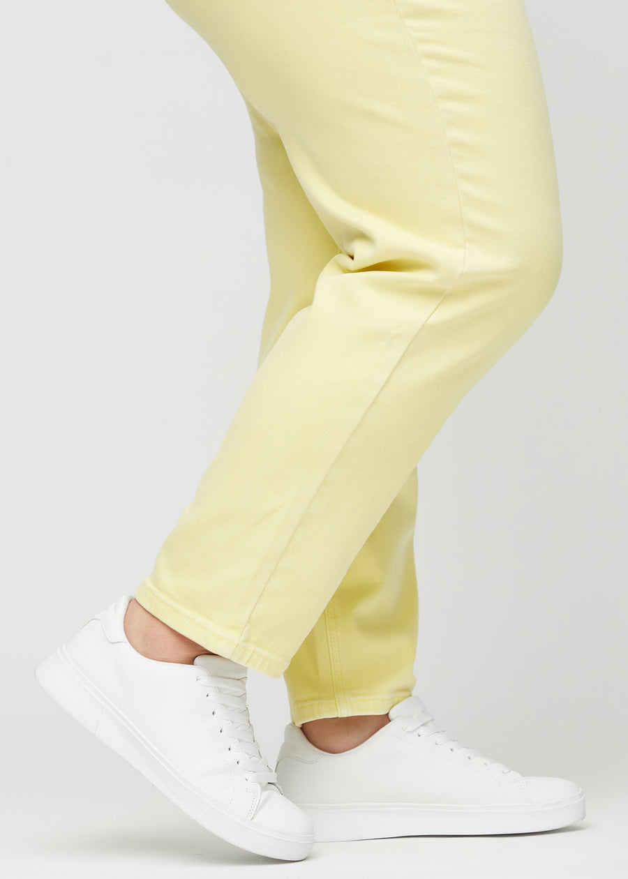 The ankles of a plus-size model, so you can see how loose the jeans fit.