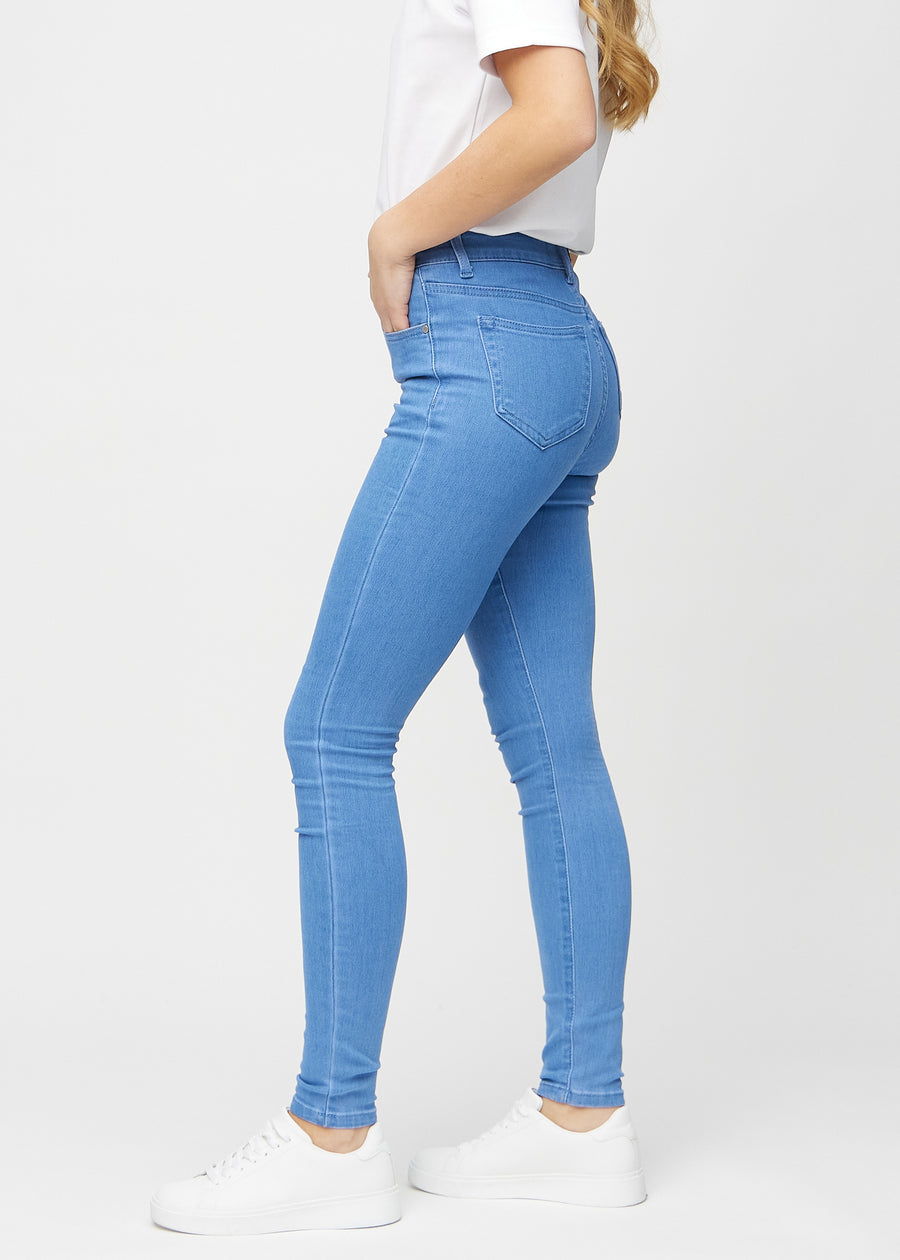 Skinny jeans for women in blue, color Geraniums. Side view on a model.