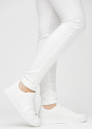The ankles of a model, so you can see how tightly the jeans fit.