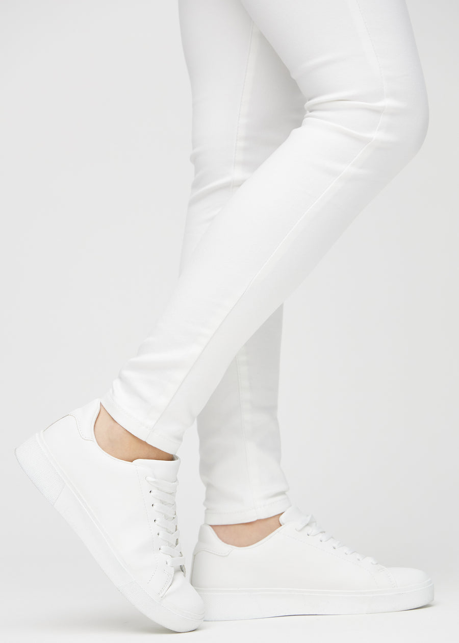The ankles of a model, so you can see how tightly the jeans fit.
