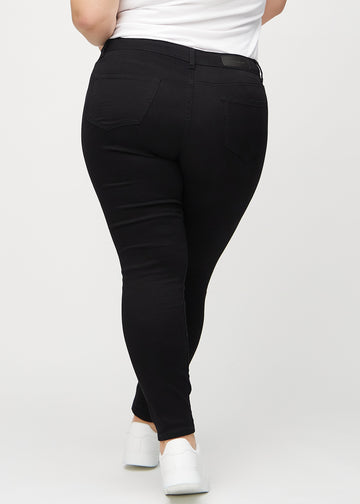 Black skinny jeans seen from the back on a plus-size model, so the full product can be seen.