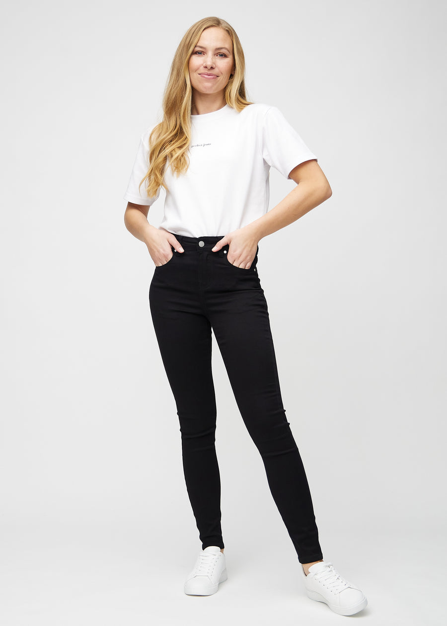 Full image of model in black skinny jeans.