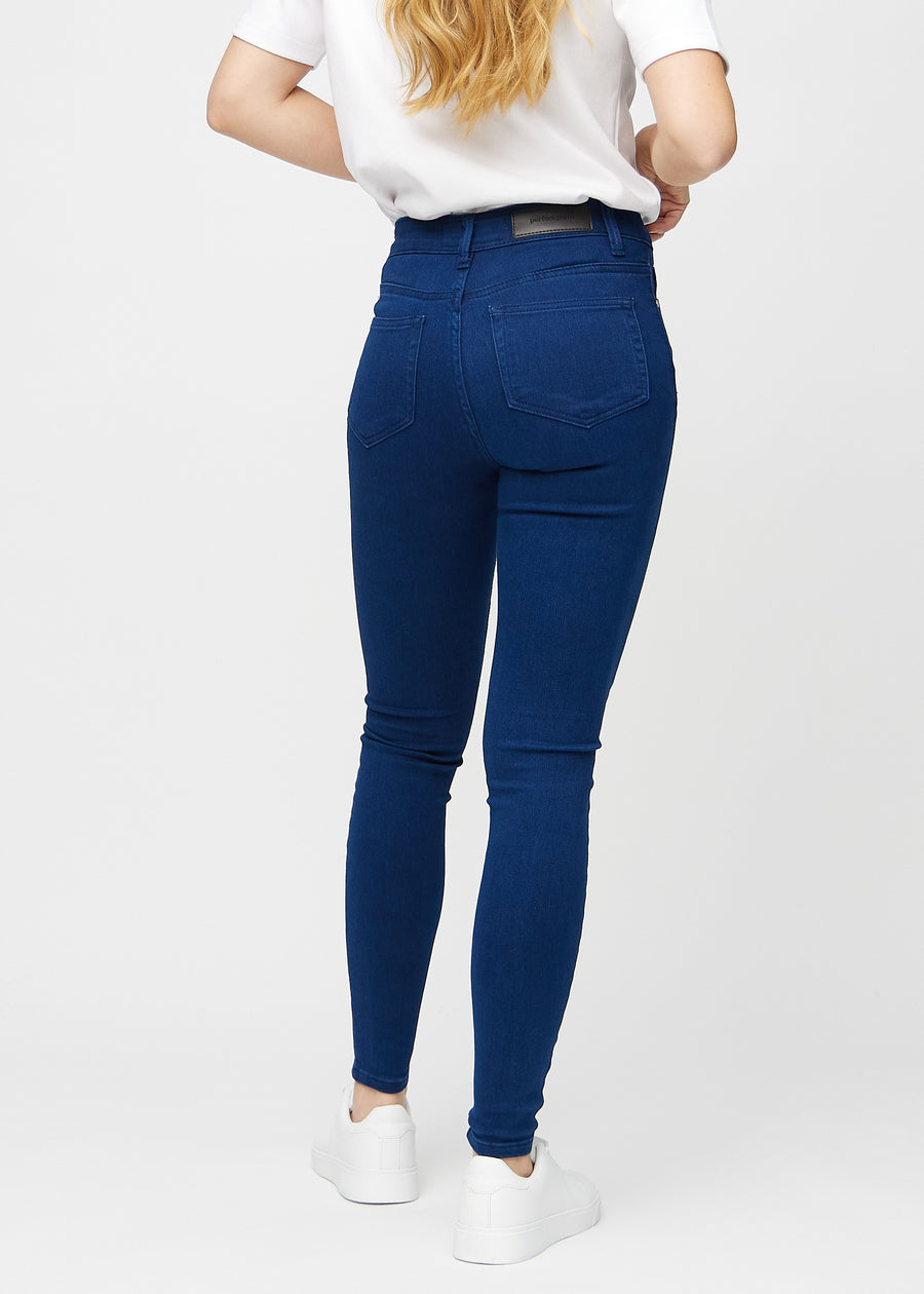 Dark blue skinny jeans viewed from the back, so you can see the entire product.