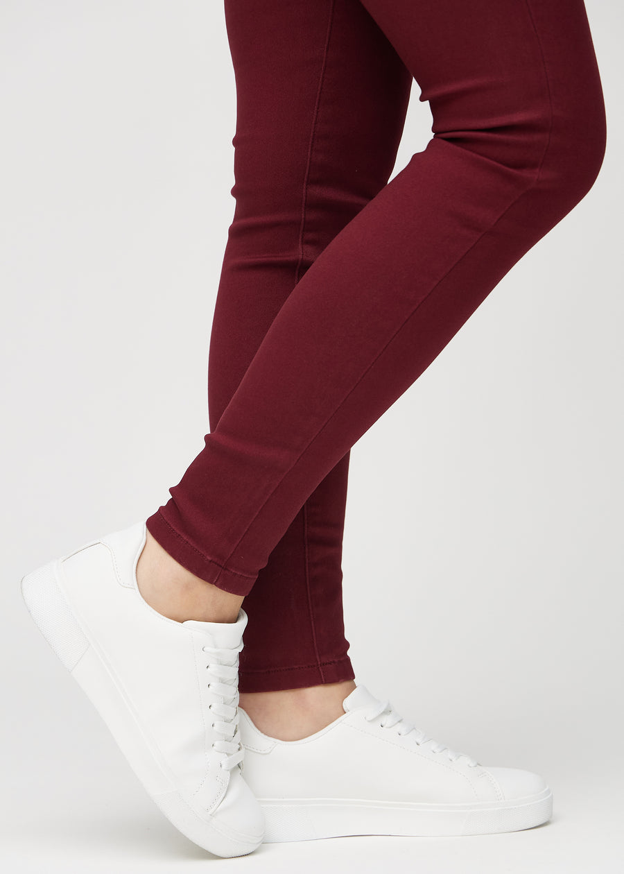 The ankles of a model, so you can see how tightly the jeans fit.