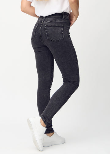 Skinny jeans for women in dark grey, color Shadows. Back view on a model, showing the full fit.
