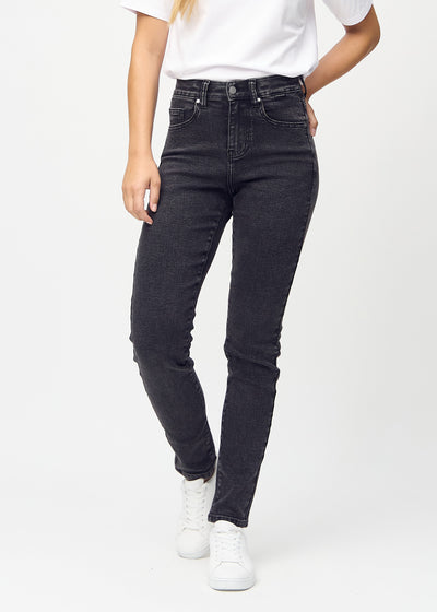 Dark grey denim slim jeans, model name Shadows, which fits close to the leg, though slightly looser at the ankle, seen from the front.
