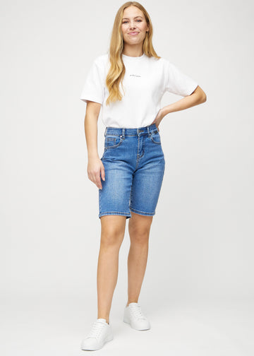 Full image of a model in denim regular middle shorts.
