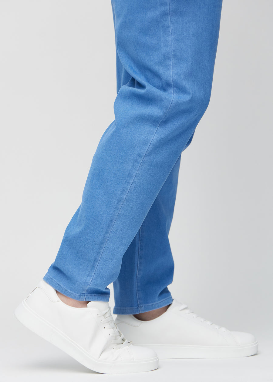 The ankles of a plus-size model, so you can see how loose the jeans fit.