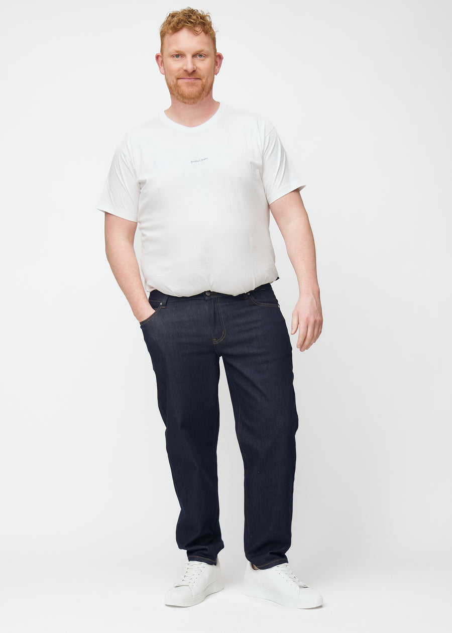 Full image of a plus-size model in deep dark blue denim jeans for men in the color Midnights with a regular fit.