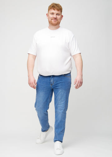 Full image of a plus-size model in denim regular jeans.