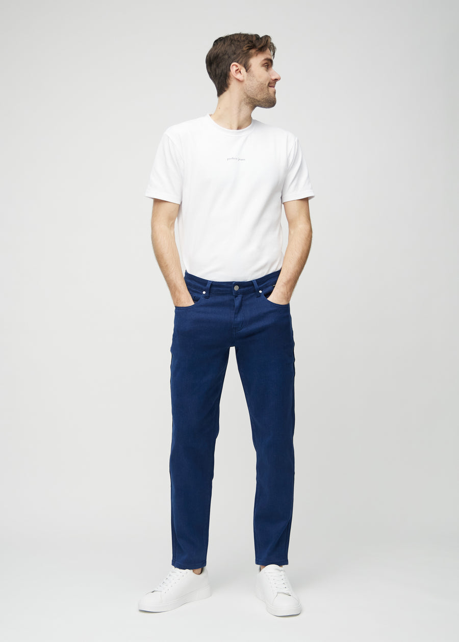 Full image of model in dark blue regular jeans.