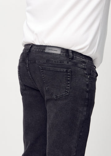 Dark grey denim regular jeans viewed from the back close up on a plus-size model to show details.
