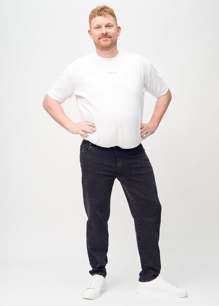 Full image of a plus-size model in dark grey denim regular jeans.