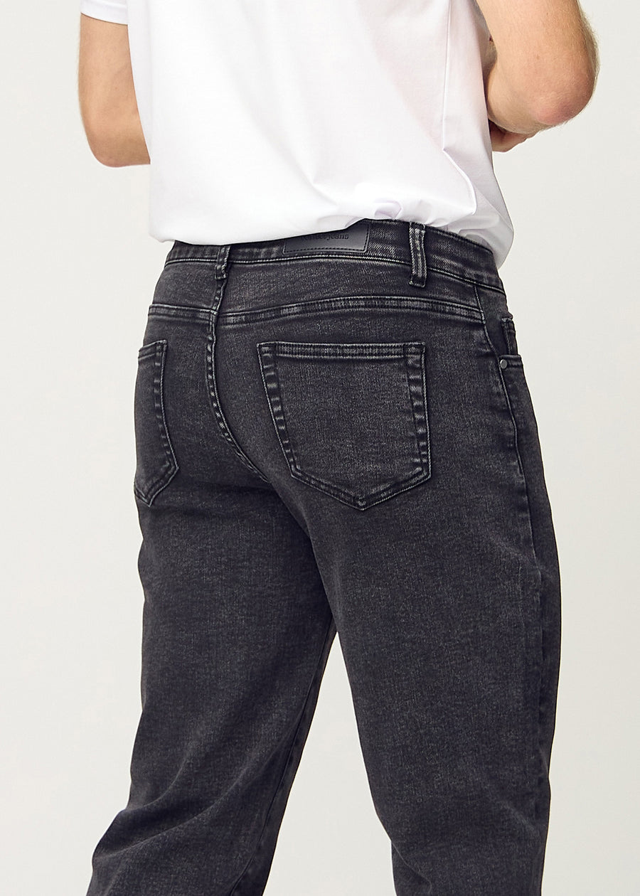 Dark grey denim regular jeans viewed from the back close up to show details.