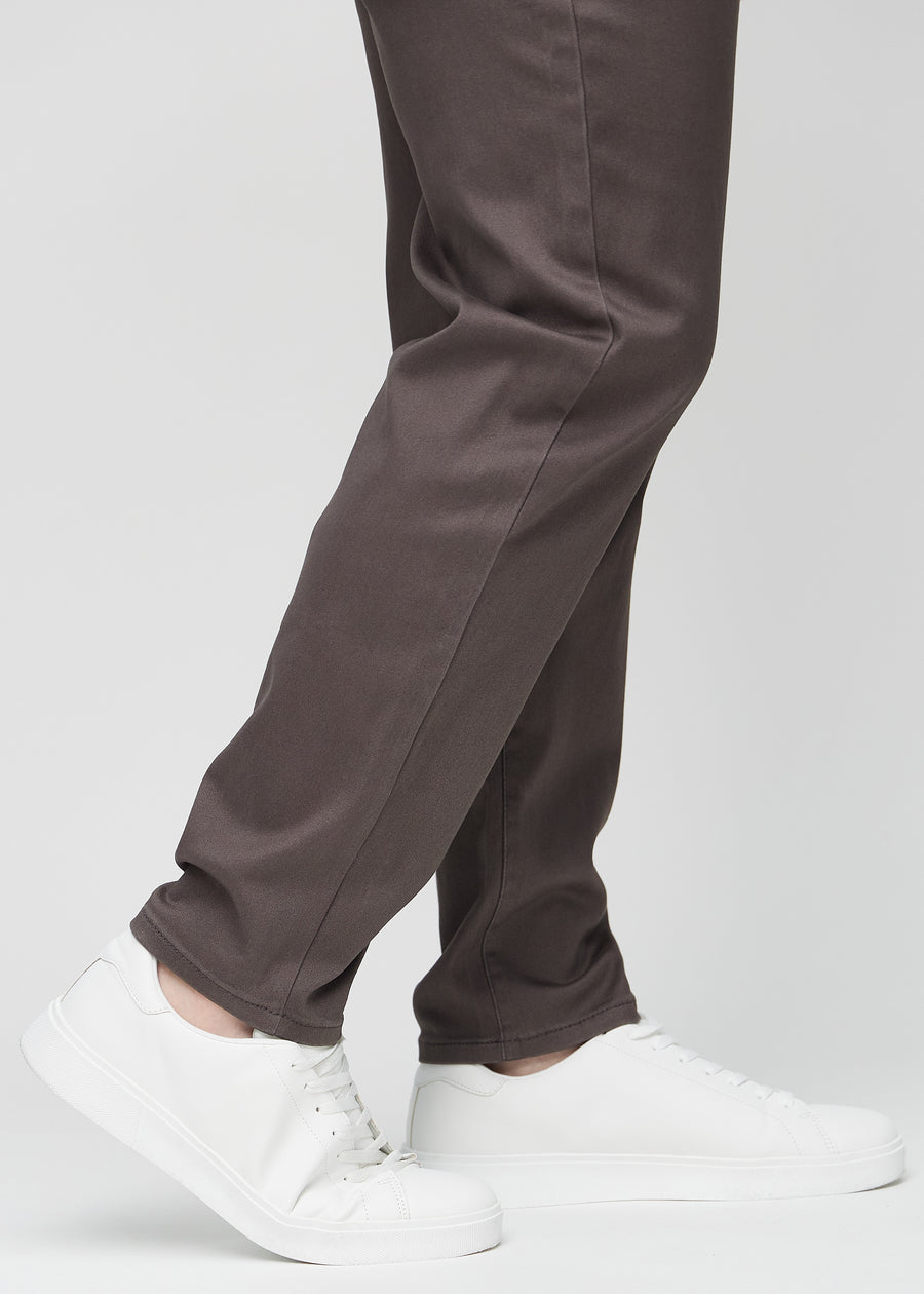The ankles of a plus-size model, so you can see how loose the jeans fit.
