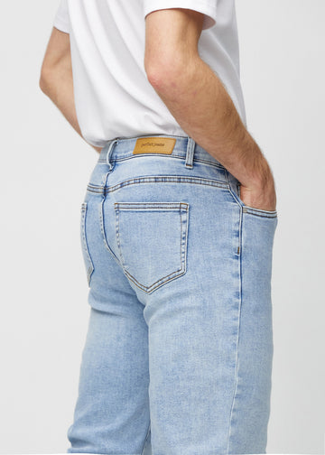 Light denim regular jeans seen from the back up close to show details.