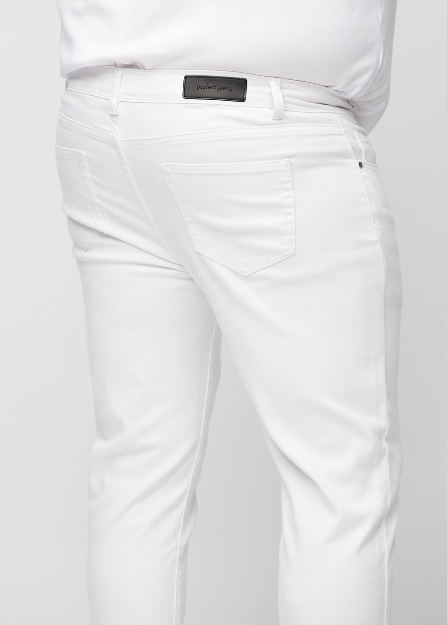Close-up back view of white slim jeans on a plus-size model showing details.