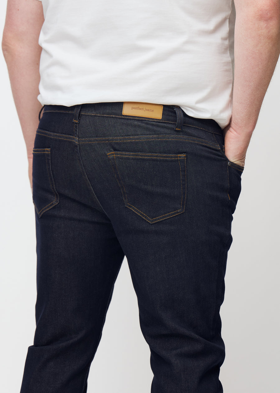 Deep dark blue denim jeans for men in the color Midnights seen from the back close up on a plus-size model.