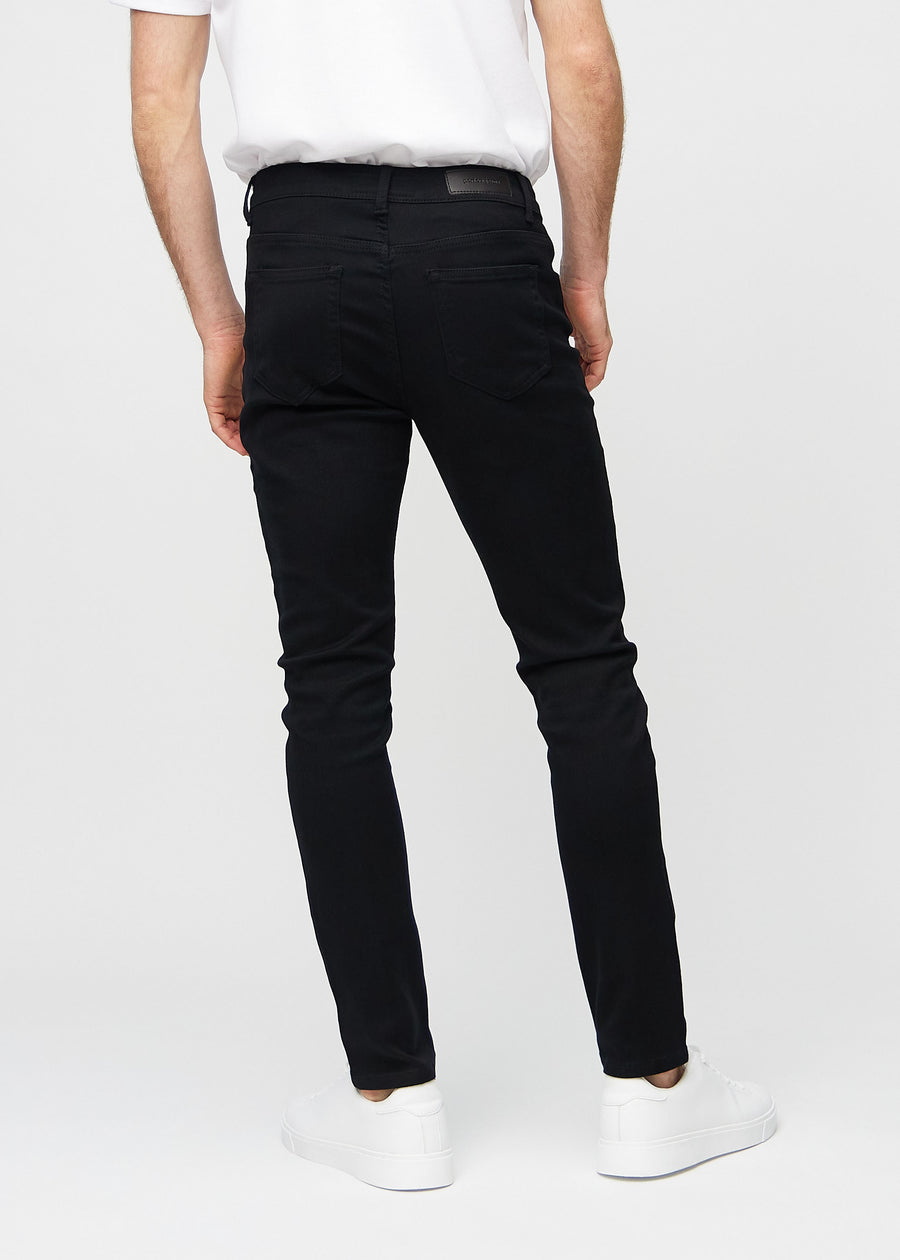 Black slim jeans viewed from the back to show the full product.
