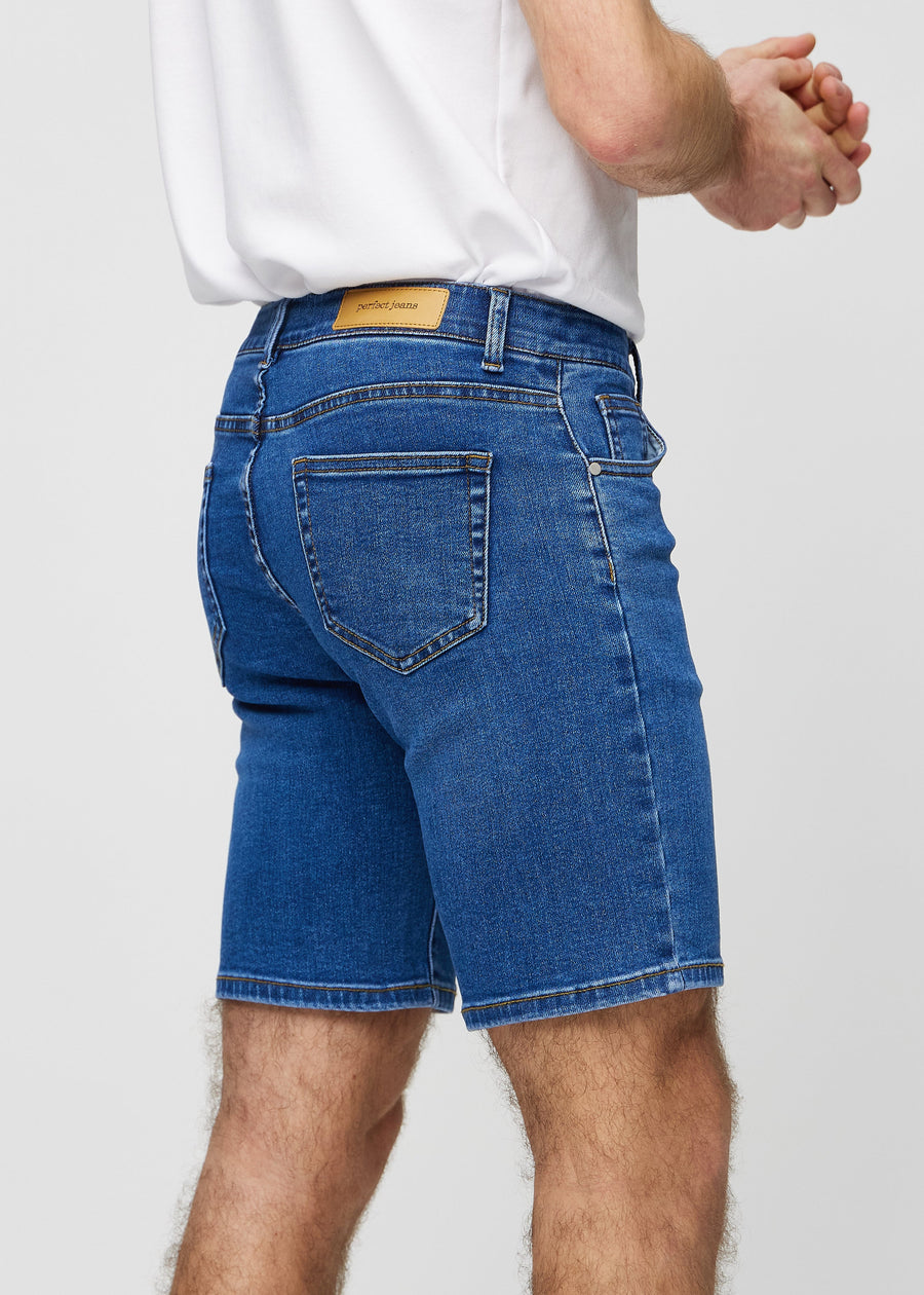 Dark denim middle-slim shorts seen from the back close up to show details.