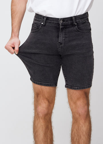 The model stretches the shorts at the thigh to show the stretch.