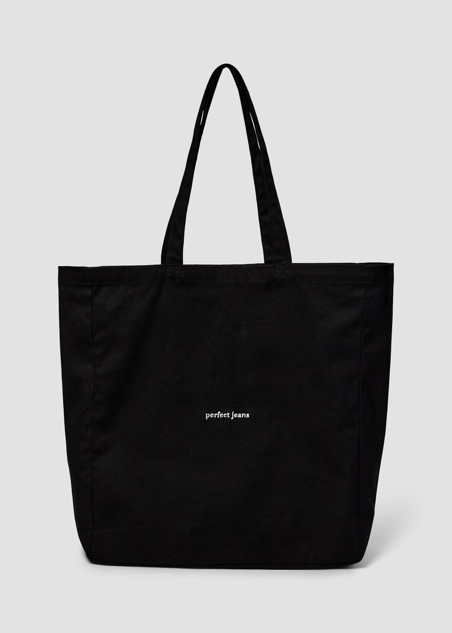 Black tote bag by Perfect Jeans with a white logo on the front.